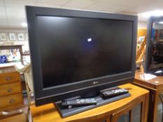 An LG 32'' LCD TV with two remotes