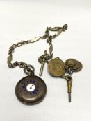 A vintage silver pocket watch with white metal chain and key with fob