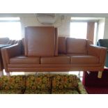 A pair of mid 20th century Scandinavian brown leather three seater settee's with matching footstool,