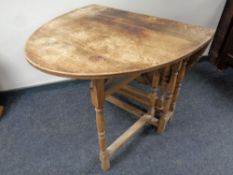 An antique oak drop leaf table