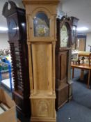 A continental stripped pine longcase clock with brass dial,