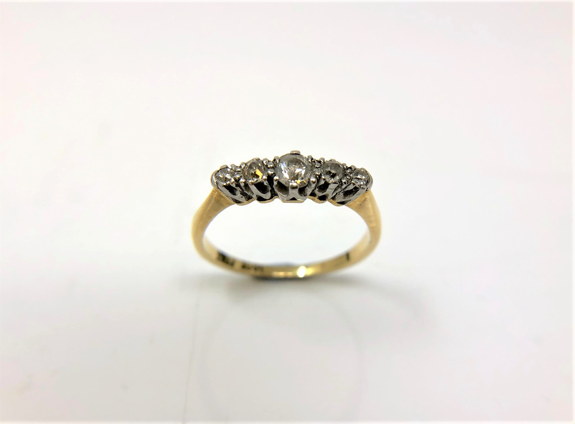 An 18ct gold and platinum five stone old-cut diamond ring, size O.