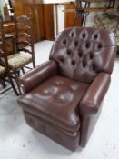 A brown button leather armchair