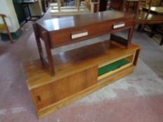 A 20th century Danish low table fitted two drawers together with a sliding door unit