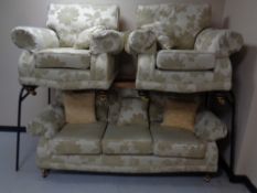 A three piece lounge suite upholstered in a floral fabric