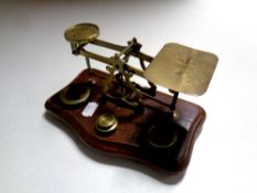 A set of antique brass postal scales with weights