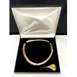 A flat link gold plated necklace with matching leaf brooch