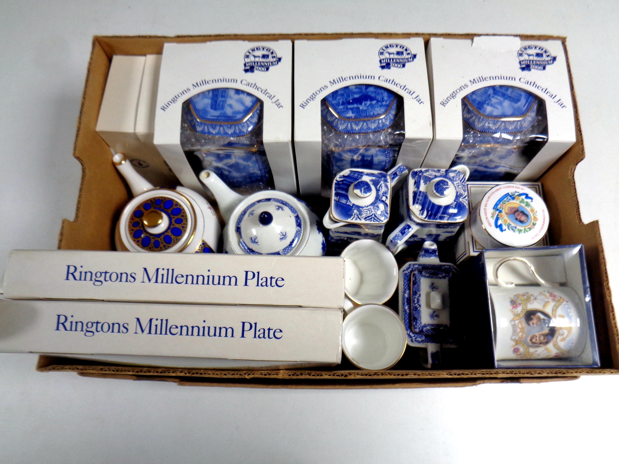 A box containing a quantity of boxed and unboxed Ringtons ceramics to include Millennium jars,