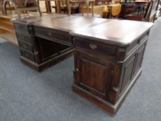 A reproduction Victorian style twin pedestal partner's desk with three leather inset panels,