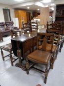 A 20th century oak drop leaf table together with four chairs
