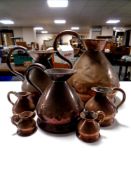 A set of seven 19th century graduated copper jugs