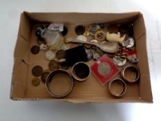 A small collection of coins, 1820 Portuguese coin, three silver napkin rings, silver decanter label,