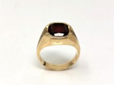 A garnet signet ring, stamped both '9' and '10k', size U. CONDITION REPORT: 9.5g.