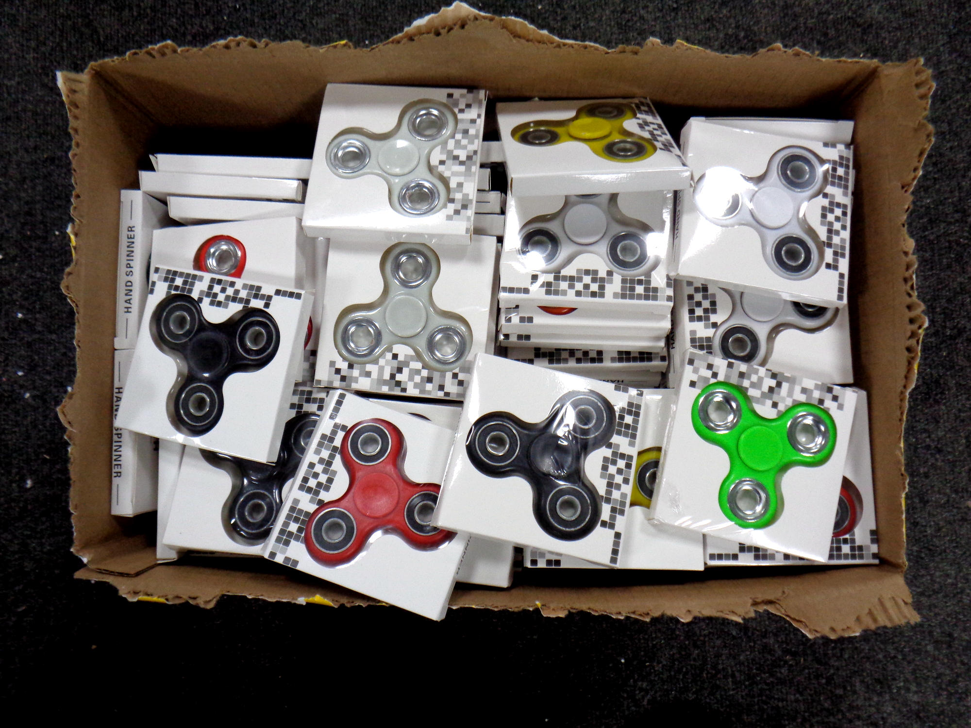 A box containing a large quantity of fidget spinners