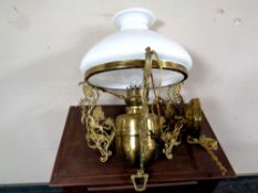 An early 20th century ornate brass hanging light fitting with opaque glass shade