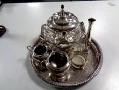 A circular plated tray of three piece EPBM tea service, plated basket, bud vase,