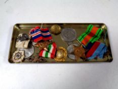 A quantity of military badges, World War II medals to include The Italian Star, Defence Medal,