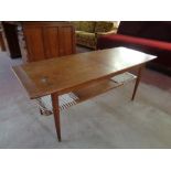 A mid 20th century Danish teak extending coffee table with under shelf