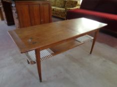 A mid 20th century Danish teak extending coffee table with under shelf