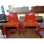 A pair of 1970s moulded plastic dining chairs with cushions