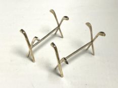 A pair of silver knife rests modelled as golf clubs