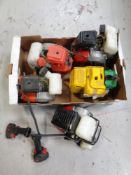 A box containing five petrol brush cutter engines