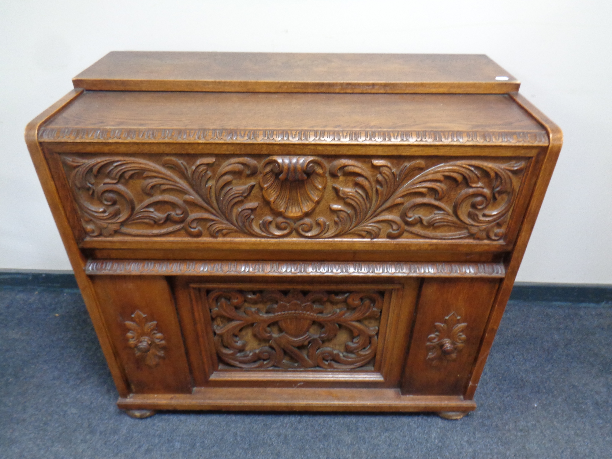 A 20th century carved oak radiogram cabinet