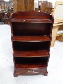 A set of reproduction mahogany open bookshelves fitted a drawer