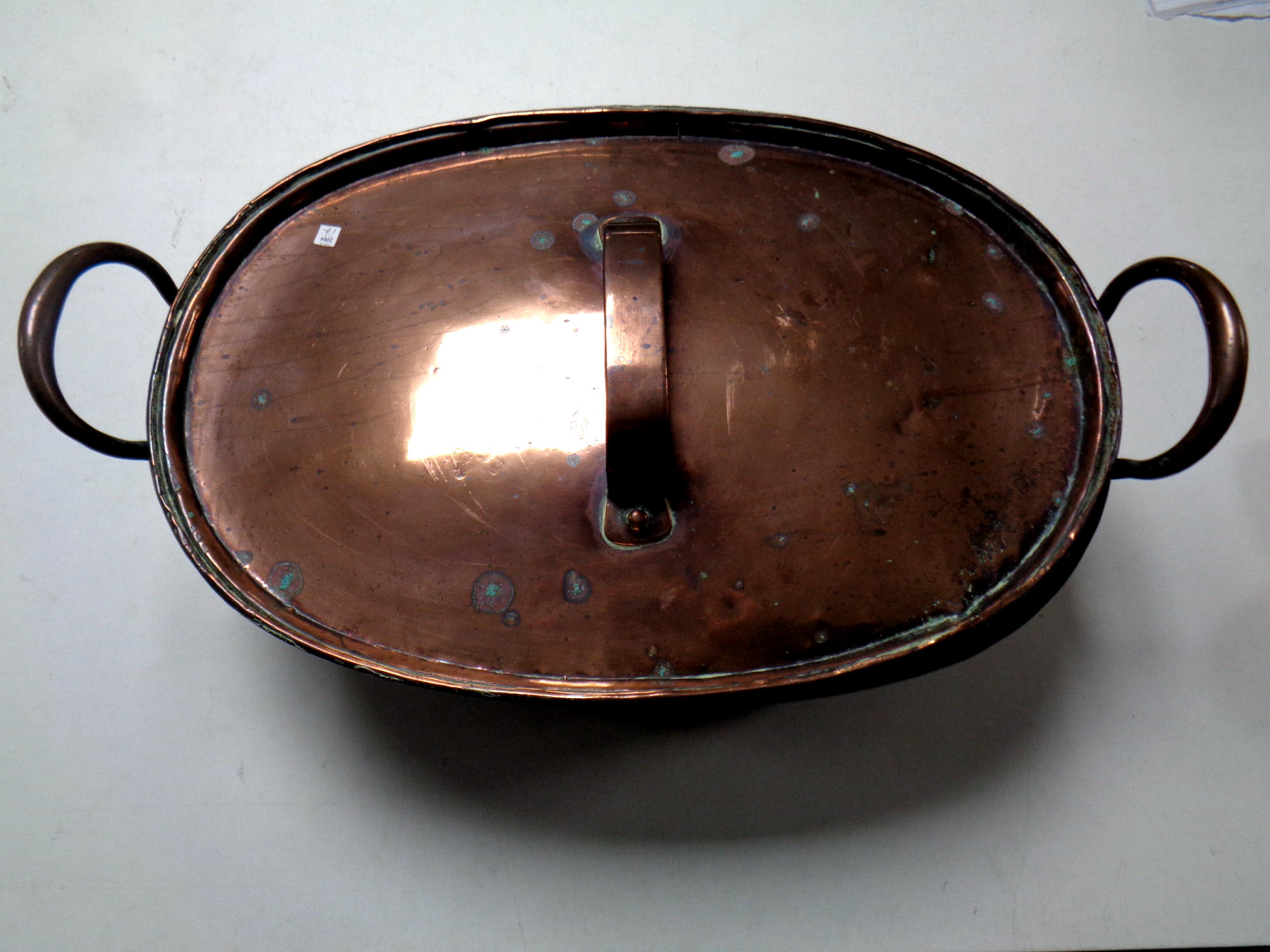 A George III copper twin handled cooking pot with lid