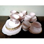 A tray containing a 39 piece English pink and gilt bone china tea service