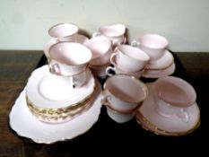 A tray containing a 39 piece English pink and gilt bone china tea service