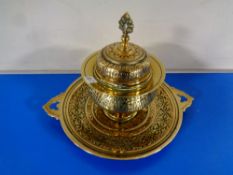 An ornate eastern brass inkwell with glass liner