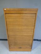 An Edwardian oak shutter front cabinet with key, width 78 cm,