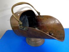 A 19th century copper brass handled coal helmet with shovel