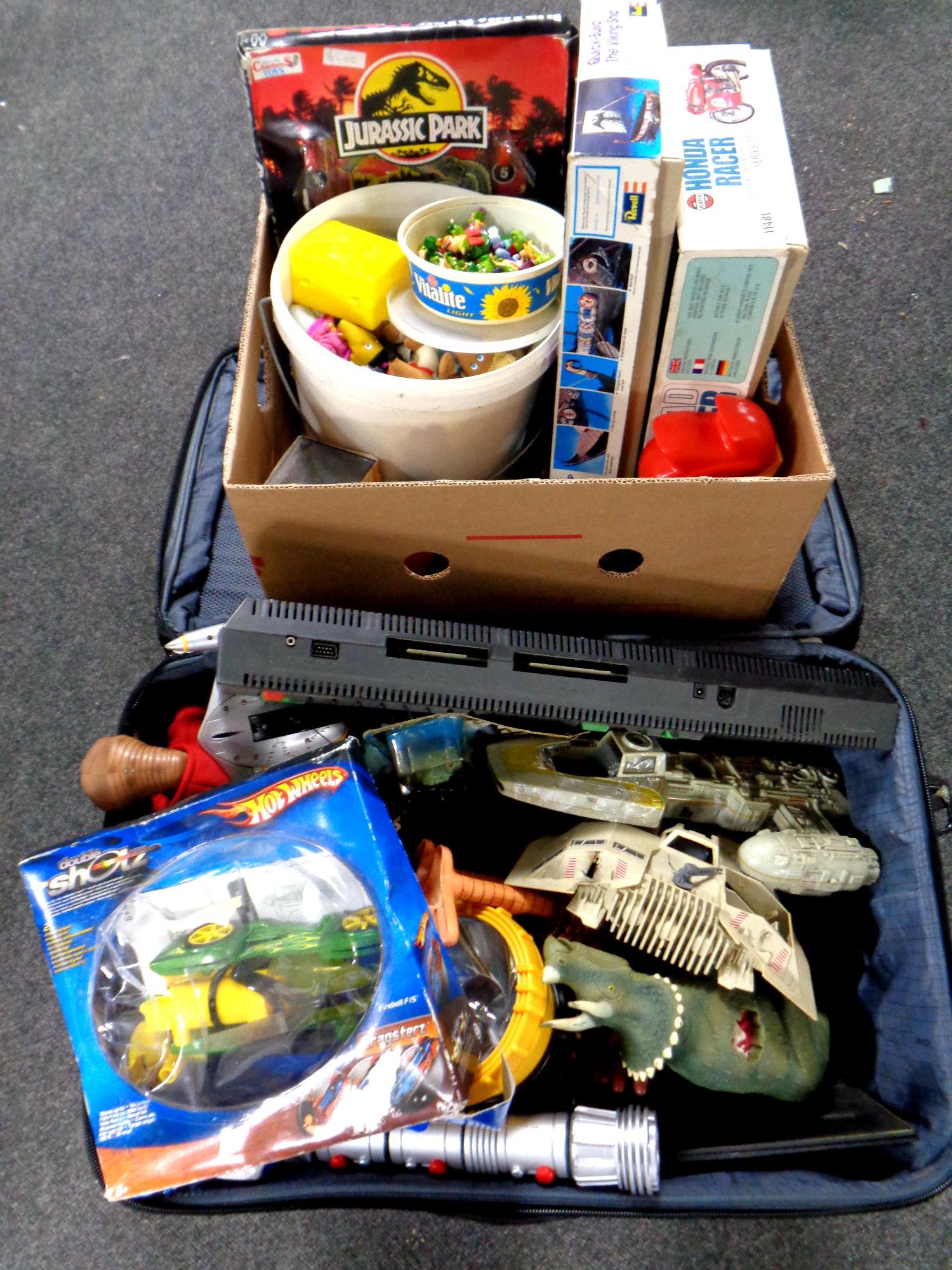 A box and a luggage case containing assorted toys to include die cast buses, Revell viking ship,