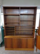 A mid 20th century Danish bookcase fitted cupboards beneath,