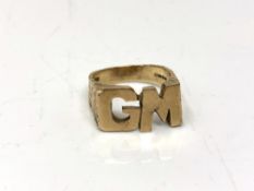 A 9ct gold ring with initials GM, size V. CONDITION REPORT: 9.