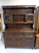 A good quality carved oak welsh dresser fitted cupboards and drawers beneath,