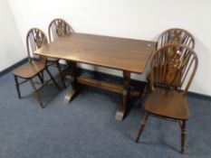 An oak refectory table and four wheel back chairs