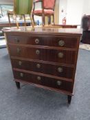 A continental four drawer chest in a mahogany finish
