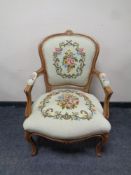 A continental carved beech salon armchair upholstered in a tapestry fabric