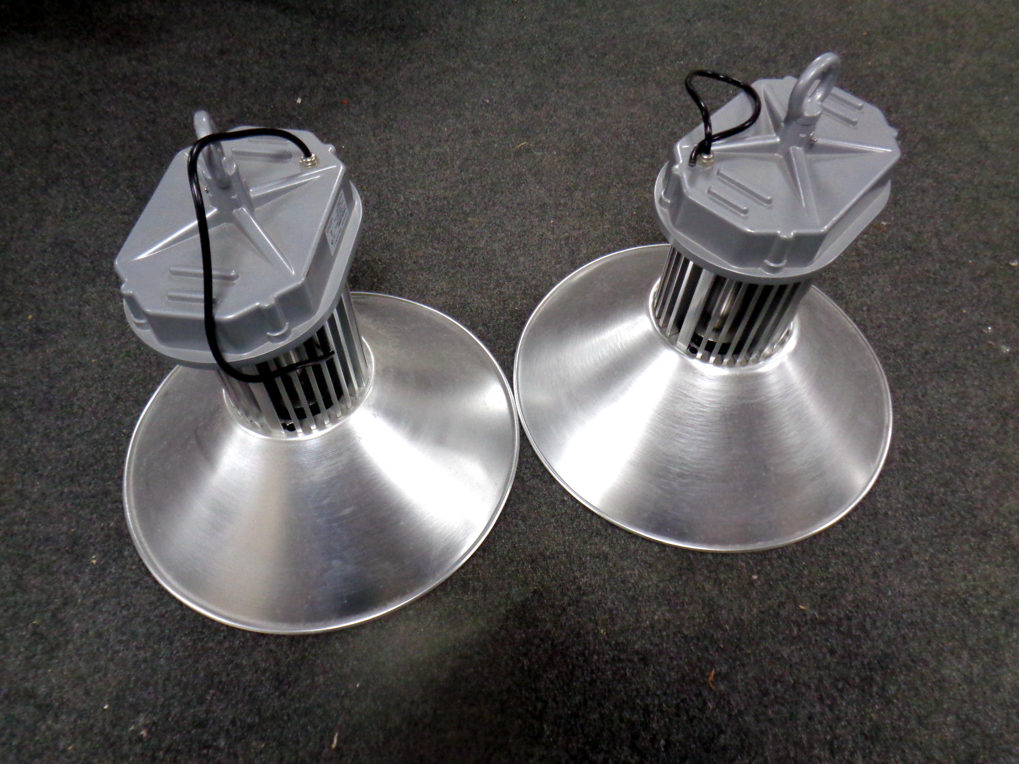 A pair of industrial style pendant light fittings,