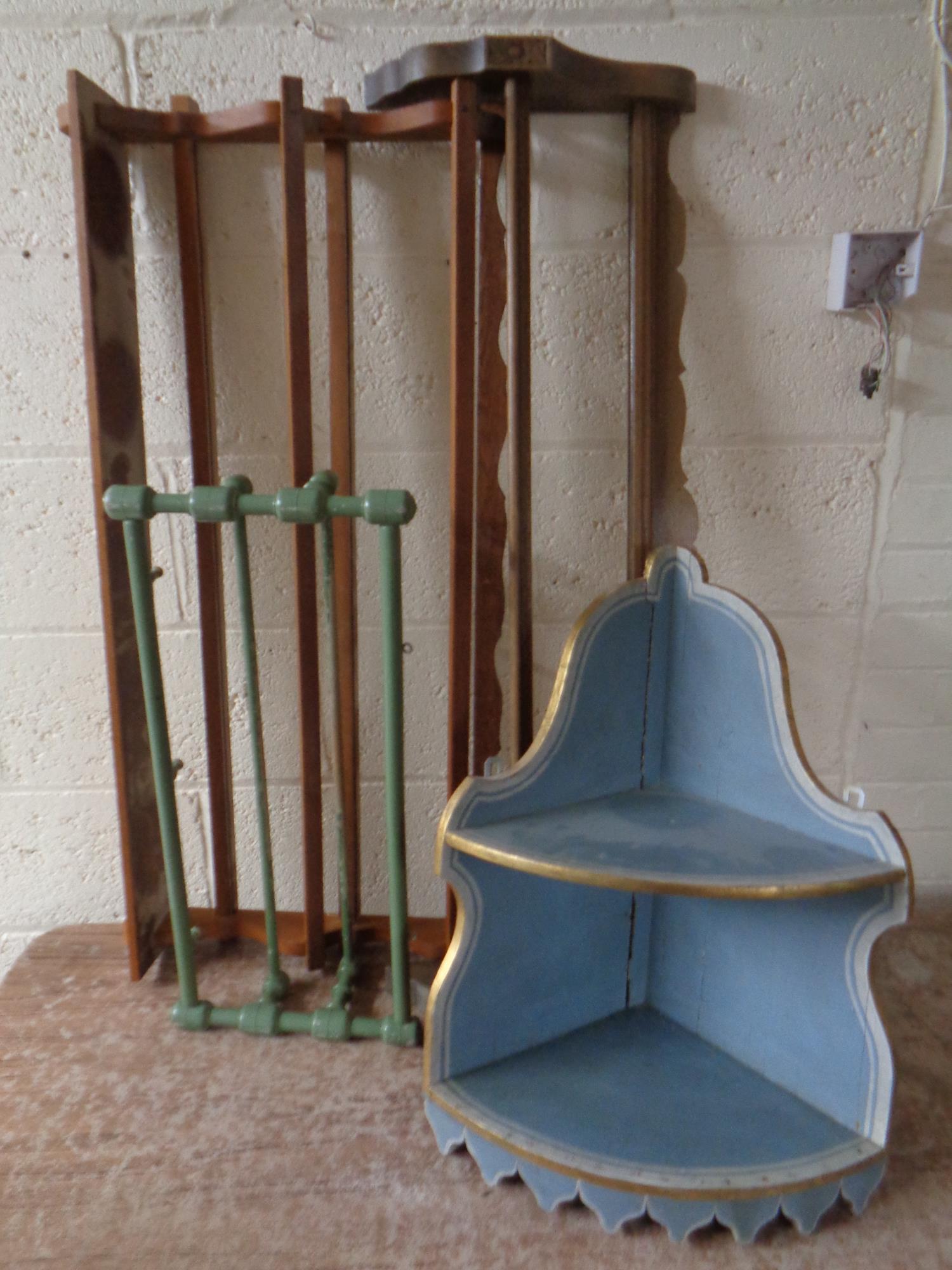 An antique painted corner wall shelf together with three wall mounted plate and clothes racks