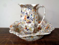 A 19th century brown chintz wash jug and basin