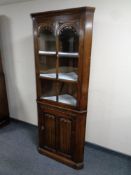 A carved oak old charm corner display cabinet fitted cupboard beneath