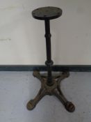 A cast iron pub table on four way pedestal