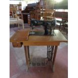 A 20th century Singer treadle sewing machine in table