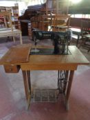 A 20th century Singer treadle sewing machine in table