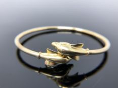 A 14ct gold dolphin bangle., 7.