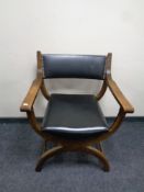 A 20th century continental oak armchair on X-frame support